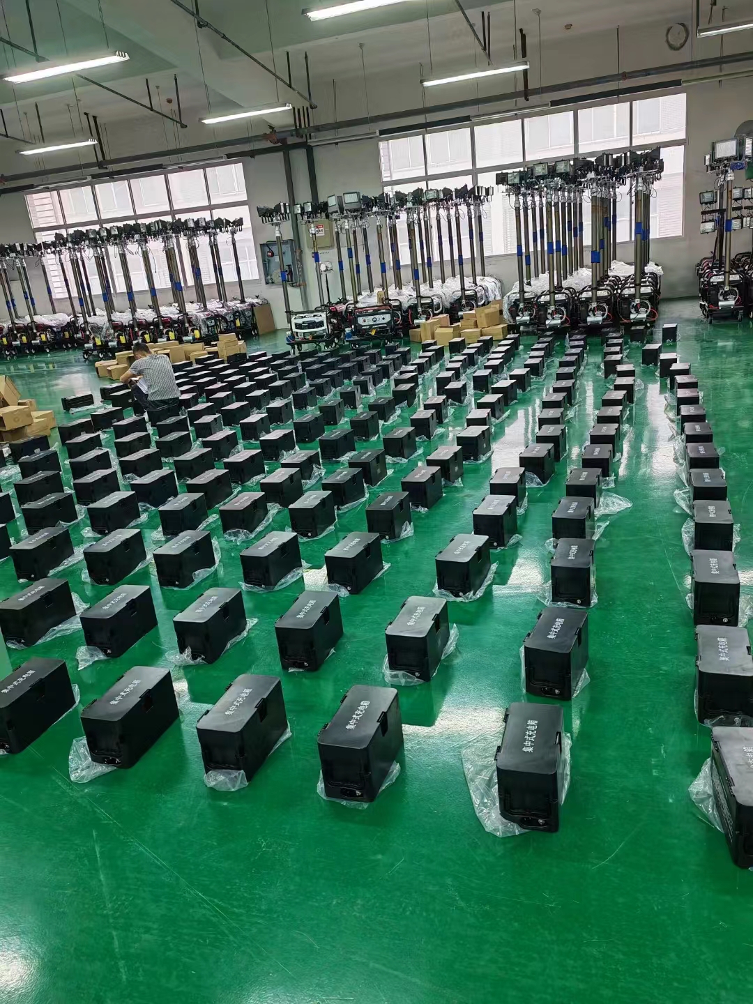 Factory workers assembling event lights